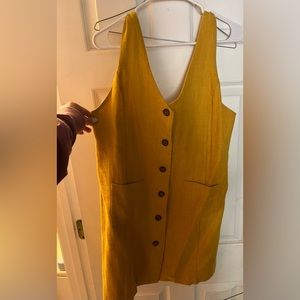 Fate yellow jumper dress with front buttons and pockets.